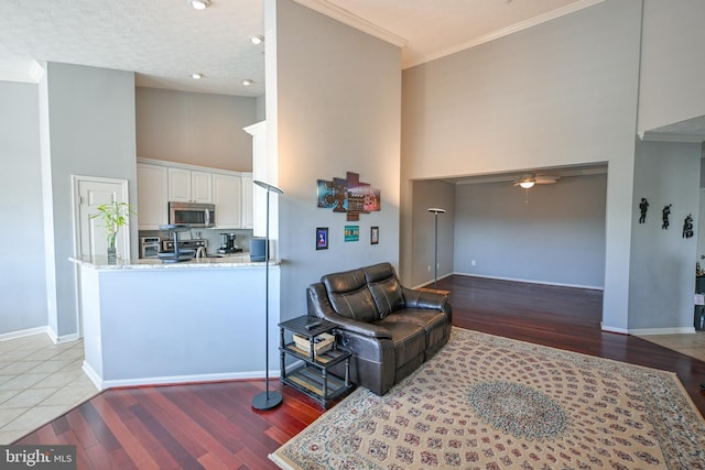 4501 Talcott Ter Unit Q, Perry Hall, MD 21128 - living room with crown molding, baseboards, a towering ceiling, and wood finished floors