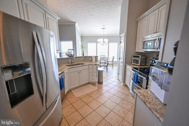 4501 Talcott Ter Unit Q, Perry Hall, MD 21128 - kitchen featuring decorative backsplash, crown molding, appliances with stainless steel finishes, a sink, and a peninsula