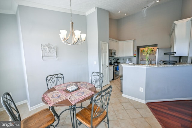 4501 Talcott Ter Unit Q, Perry Hall, MD 21128 - dining area featuring a towering ceiling, crown molding, light tile patterned floors, baseboards, and an inviting chandelier
