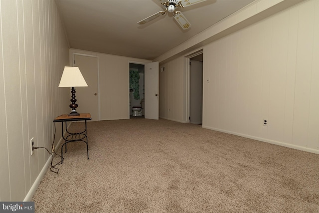 carpeted spare room featuring a ceiling fan