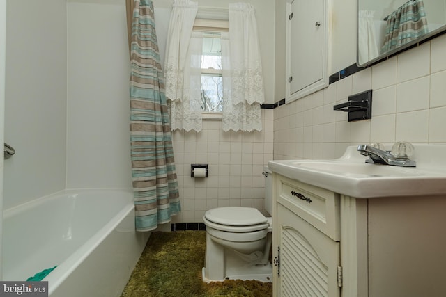 full bathroom featuring toilet, tile walls, shower / bathtub combination with curtain, and vanity