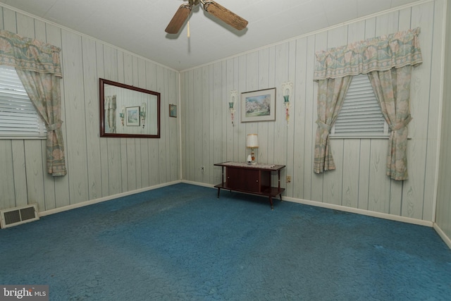empty room with visible vents, a ceiling fan, carpet, and baseboards