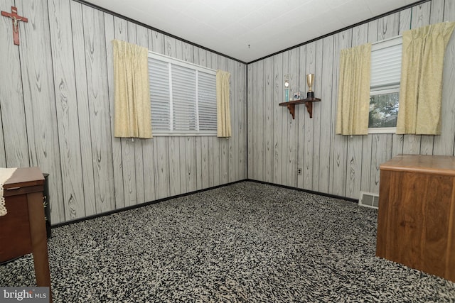 spare room with baseboards, carpet, and visible vents