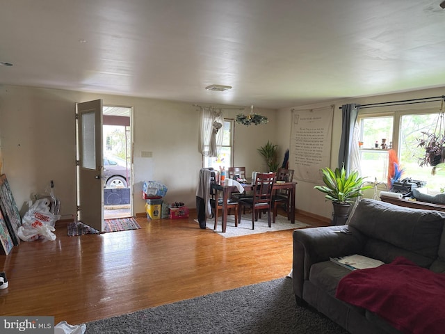 living area with wood finished floors and a healthy amount of sunlight