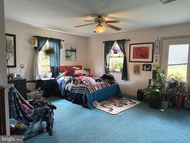 bedroom with carpet floors, multiple windows, and a ceiling fan