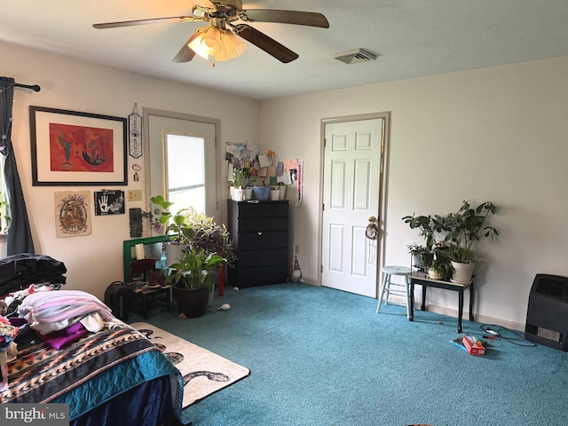 carpeted bedroom featuring ceiling fan and visible vents