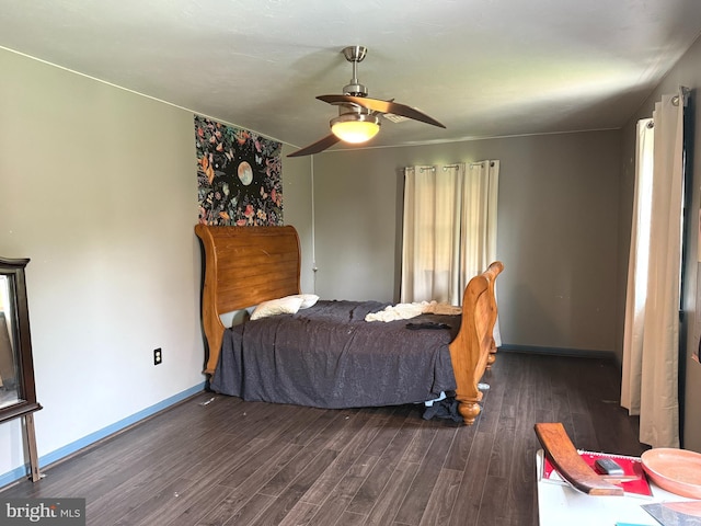 bedroom featuring baseboards, dark wood-style flooring, and ceiling fan