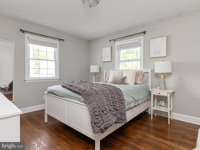 bedroom featuring baseboards and dark wood-style floors