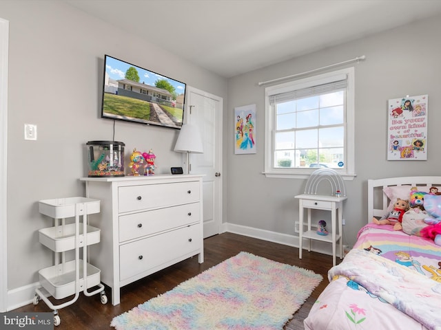 bedroom featuring baseboards and dark wood-style floors