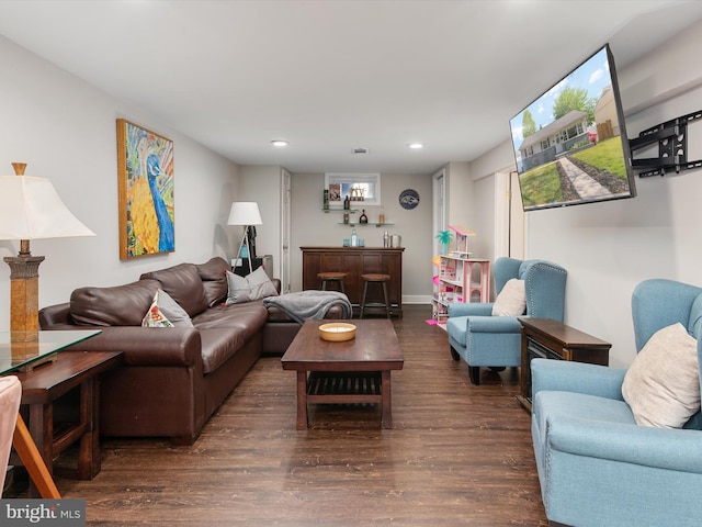 living area with indoor bar, recessed lighting, and wood finished floors