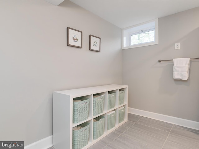 bathroom with baseboards and tile patterned flooring