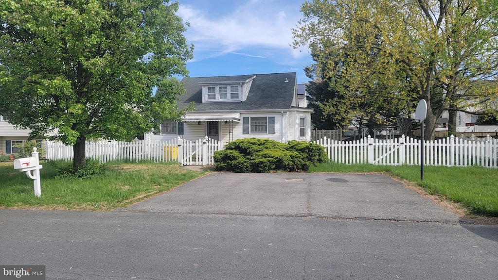 bungalow with a gate, roof with shingles, and a fenced front yard