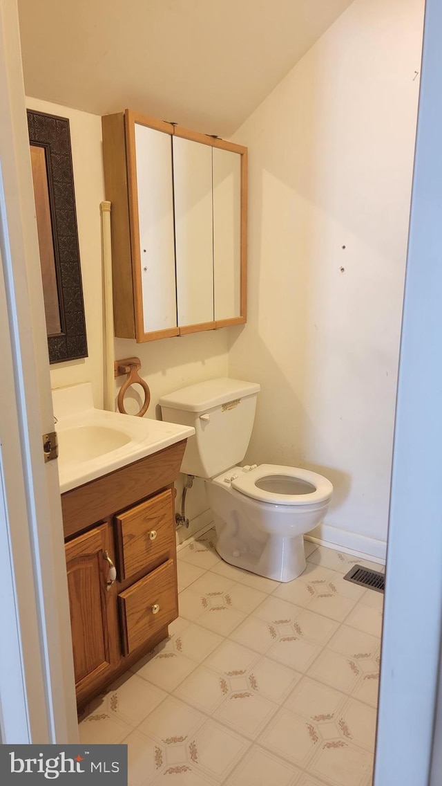 807 Riverside Dr, Pasadena, MD 21122 - half bathroom with vanity, toilet, and baseboards
