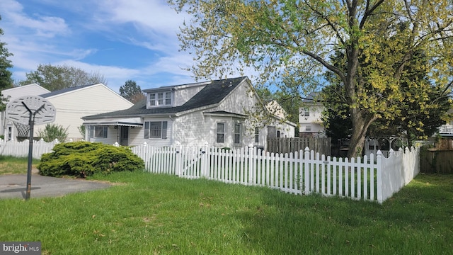 view of front of property with fence private yard and a front yard