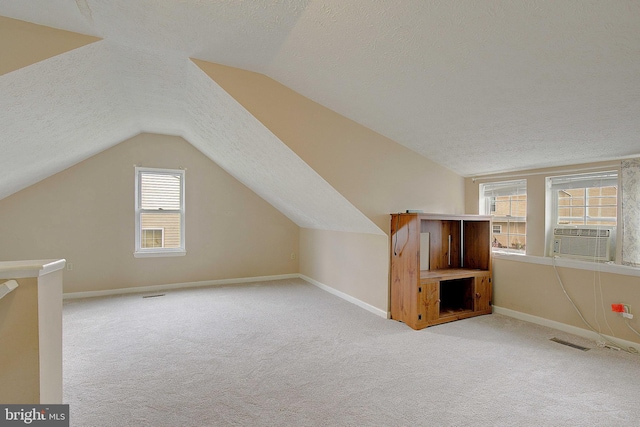 807 Riverside Dr, Pasadena, MD 21122 - bonus room with a textured ceiling, lofted ceiling, carpet, cooling unit, and baseboards