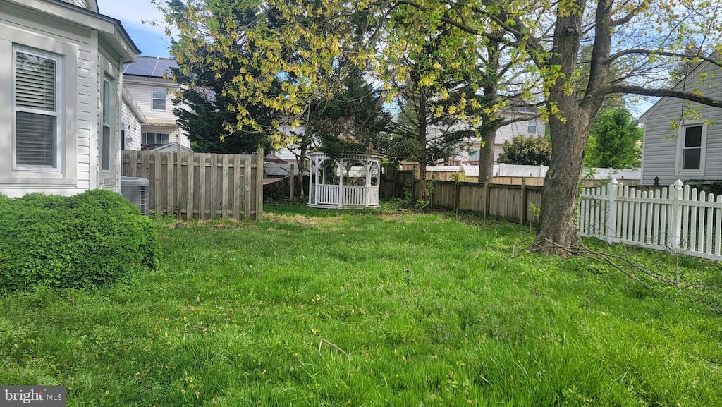 view of yard featuring a fenced backyard and central AC unit