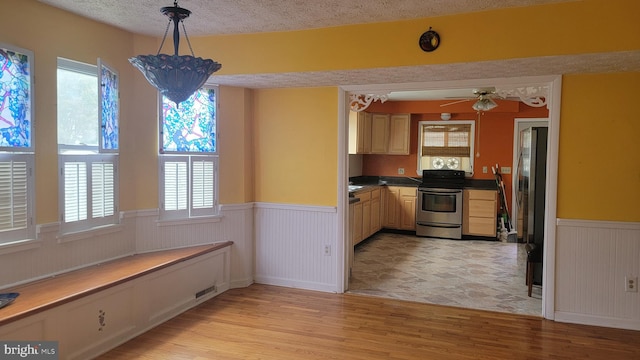 807 Riverside Dr, Pasadena, MD 21122 - kitchen with appliances with stainless steel finishes, a wainscoted wall, healthy amount of natural light, light wood-style flooring, and ceiling fan