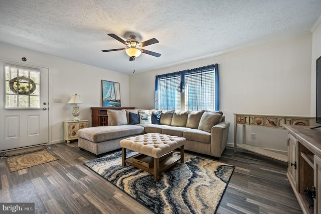 living room featuring baseboards, a textured ceiling, ceiling fan, and dark wood finished floors