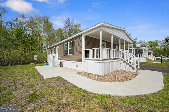 manufactured / mobile home featuring stairs and a porch