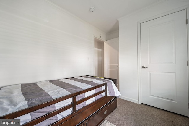 carpeted bedroom featuring crown molding