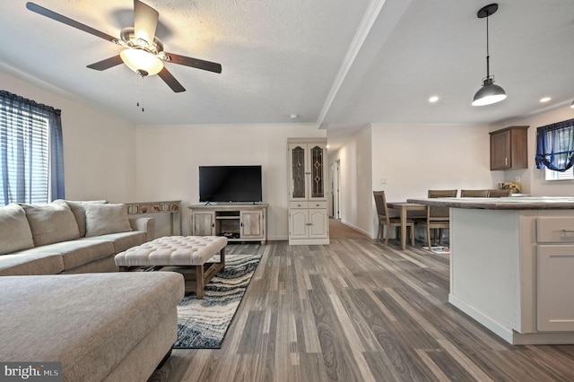 living area featuring recessed lighting, ceiling fan, baseboards, and dark wood-type flooring