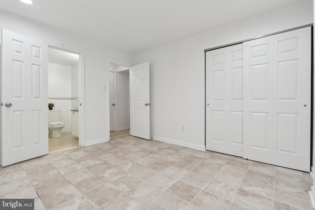 5439 Grove Ridge Way Unit 112, Rockville, MD 20852 - unfurnished bedroom with a closet, connected bathroom, baseboards, and stone finish flooring
