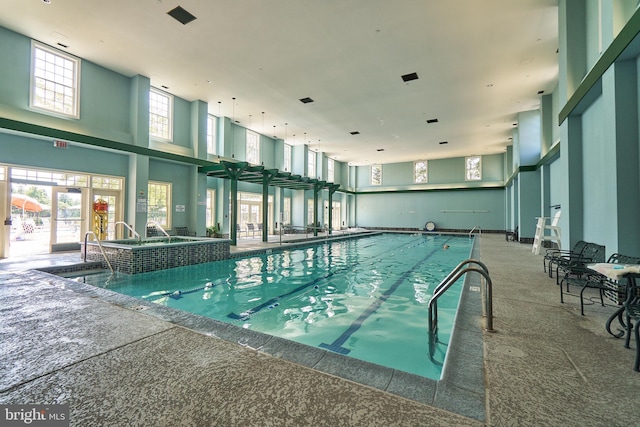 view of swimming pool with a pool with connected hot tub