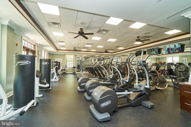 exercise room with ceiling fan, a drop ceiling, and visible vents