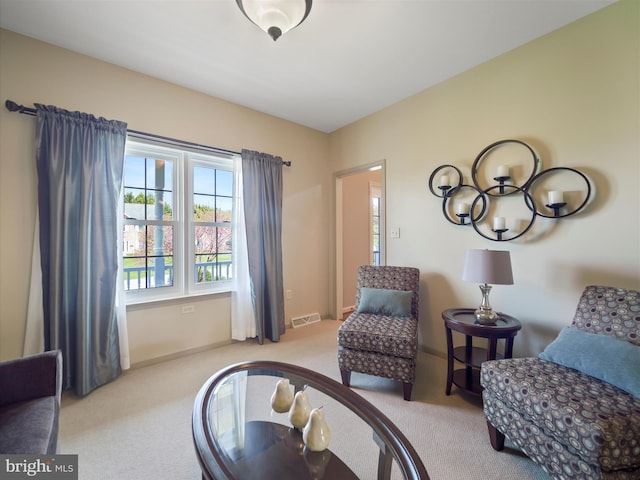 living area with carpet flooring, baseboards, and visible vents