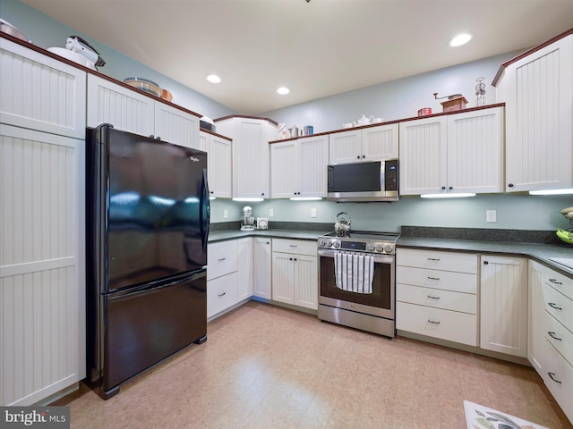 kitchen featuring dark countertops, stainless steel appliances, and recessed lighting