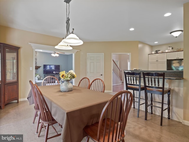 dining space featuring recessed lighting, baseboards, ceiling fan, and stairway