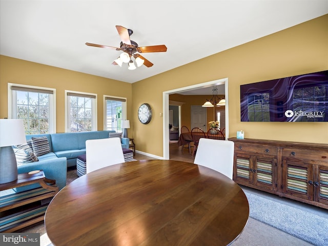 dining area with baseboards and ceiling fan