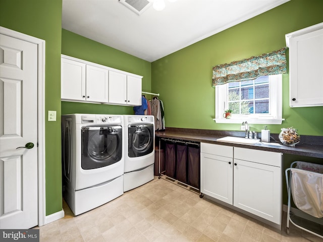 laundry room with a sink, visible vents, cabinet space, and washer and dryer
