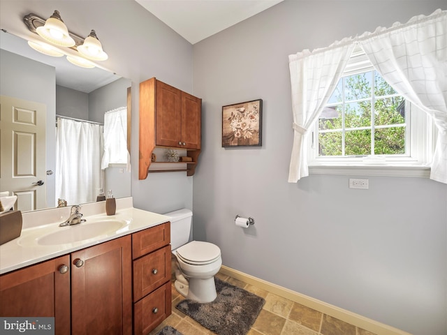 full bath featuring baseboards, toilet, and vanity