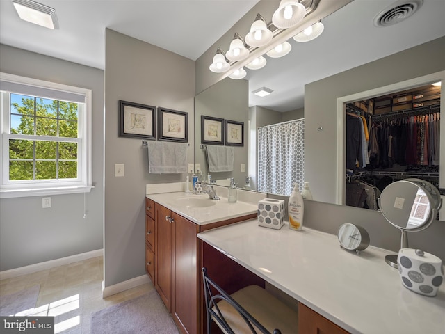 full bathroom featuring visible vents, baseboards, and vanity