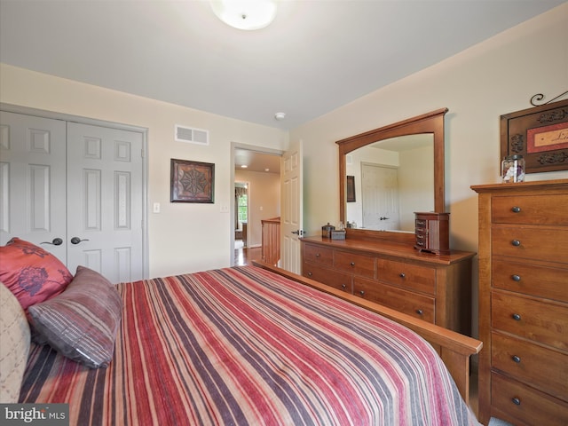 bedroom with a closet and visible vents