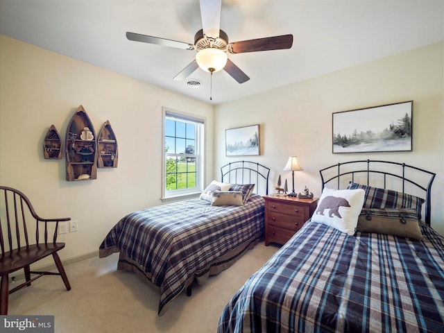 bedroom with baseboards, visible vents, light carpet, and ceiling fan