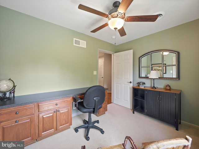 office area featuring visible vents, a ceiling fan, baseboards, and light carpet