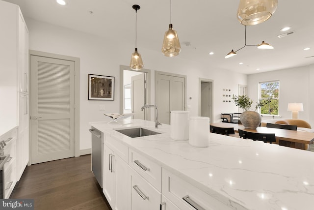 770 Park Rd NW Unit 201, Washington, DC 20010 - kitchen with stainless steel appliances, white cabinets, light stone countertops, pendant lighting, and dark wood-type flooring