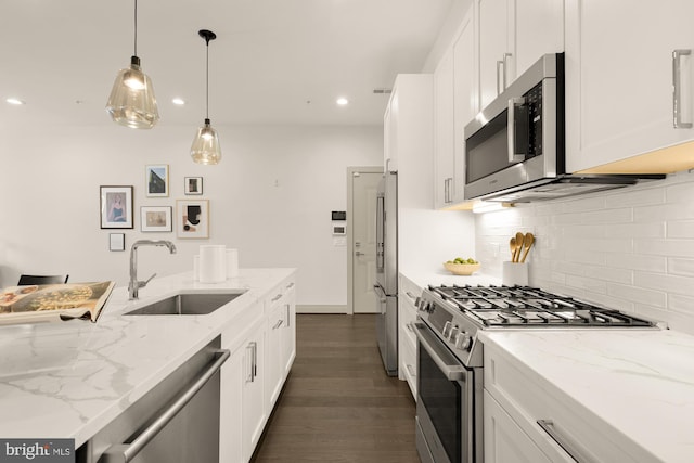 770 Park Rd NW Unit 201, Washington, DC 20010 - kitchen featuring appliances with stainless steel finishes, dark wood-type flooring, white cabinets, backsplash, and light stone countertops