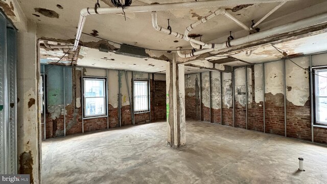 misc room with plenty of natural light and brick wall