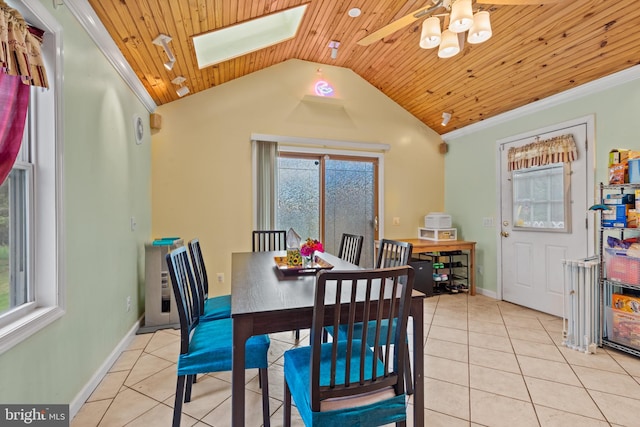 dining area with wooden ceiling, lofted ceiling with skylight, and light tile patterned flooring