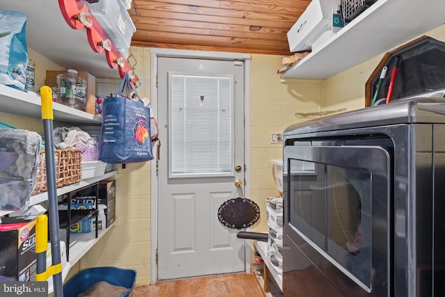 clothes washing area featuring separate washer and dryer, laundry area, and wood finished floors