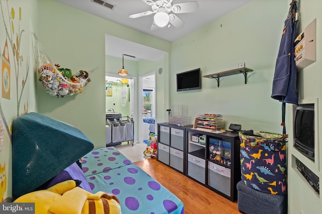game room featuring visible vents, light wood-style flooring, and ceiling fan