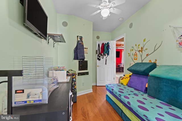 bedroom featuring baseboards, ceiling fan, and wood finished floors