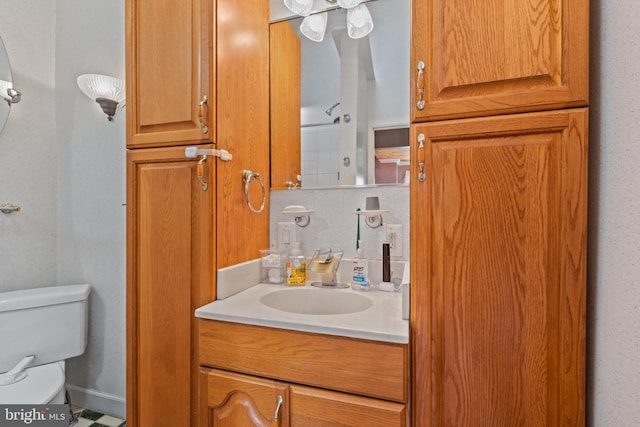 bathroom featuring toilet and vanity