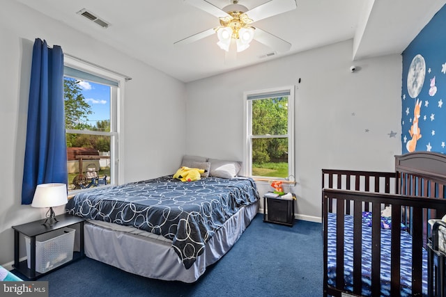 bedroom with carpet flooring, visible vents, and multiple windows