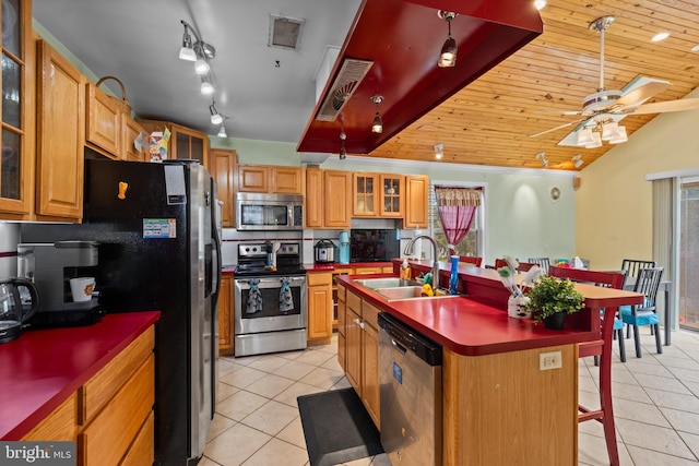 kitchen featuring light tile patterned flooring, appliances with stainless steel finishes, a sink, and visible vents