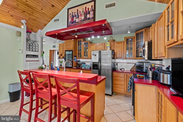 kitchen featuring light tile patterned flooring, appliances with stainless steel finishes, and visible vents