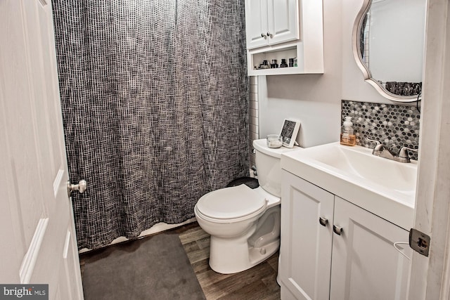 103 Dunn Ln, Pennsville, NJ 08070 - full bath featuring vanity, toilet, a shower with shower curtain, wood finished floors, and tasteful backsplash